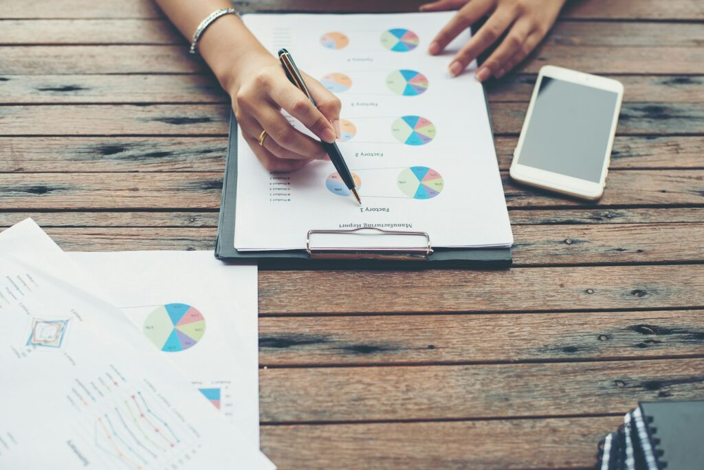 Young business woman hands analysis with business chart on workplace.